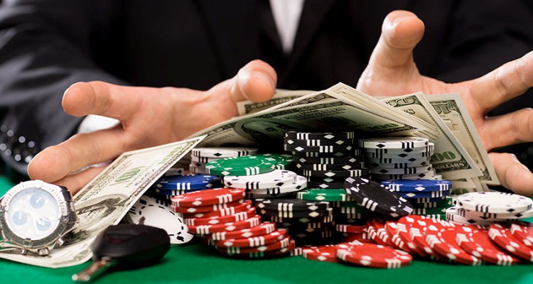 poker player with chips and money at casino table